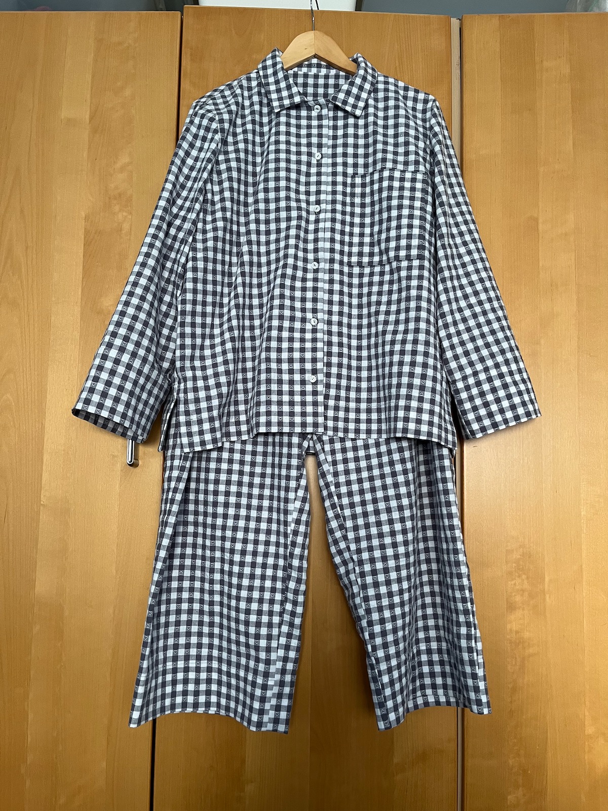 Grey and white checked pyjama set on a hanger
