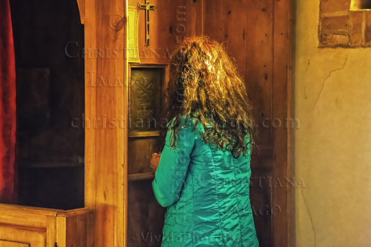 Woman confessing at the confessional