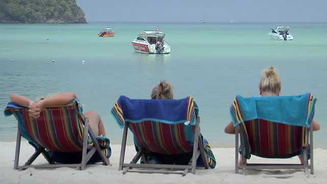 Phi Phi Island, Thailand, 3 Scandinavian Girls enjoy the sun in  Beach Chairs on Ao Ton Sai Beach, 2000s