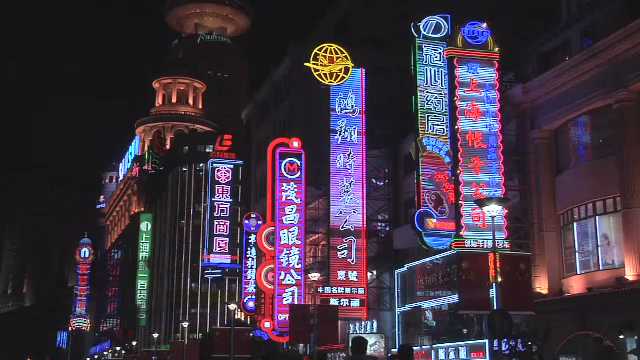Shanghai, Colorful Neon Signs on Nanjing Road East Pan to the Right, China, 2000s