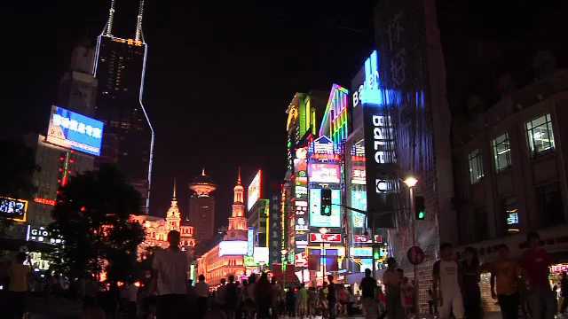 Shanghai, Colorful Neon Signs on Nanjing Road East with Pedestrian strolling in the Evening China, 2000s