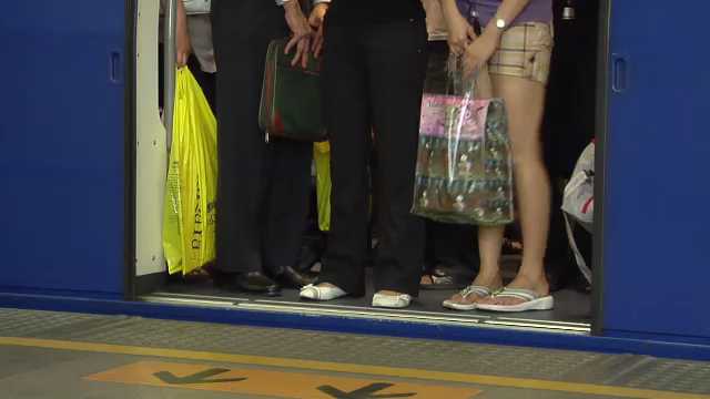 Passengers rush to catch the Skytrain at Siam Station, Bangkok, Thailand, 2000s
