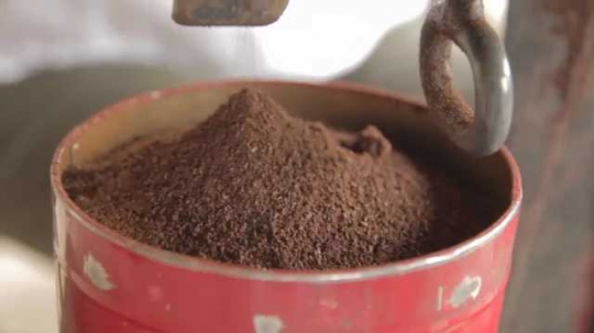 Coffee Pouring Into Can From Grinder Close-Up, Indonesia, 2010s