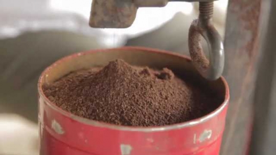 Coffee Pouring Into Can From Grinder Close-Up, Indonesia, 2010s