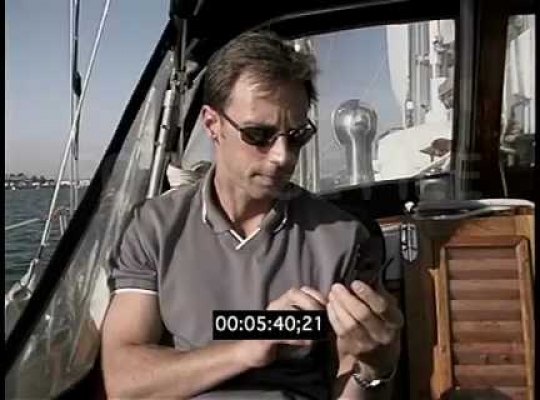 Man on Yacht Making Call on Cell Phone, USA, 2000s