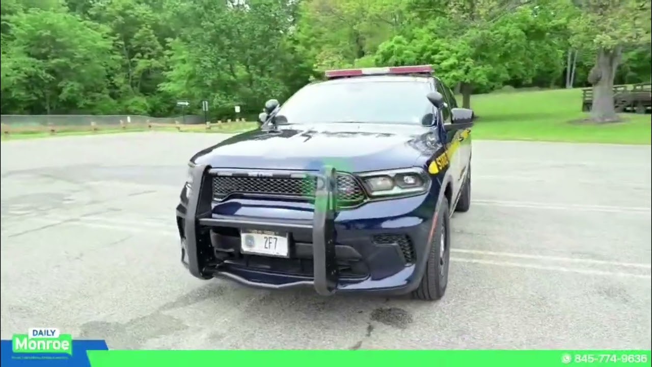 New Dodge Durango police vehicle arrives at Monroe State Police barracks, replacing crashed unit.
