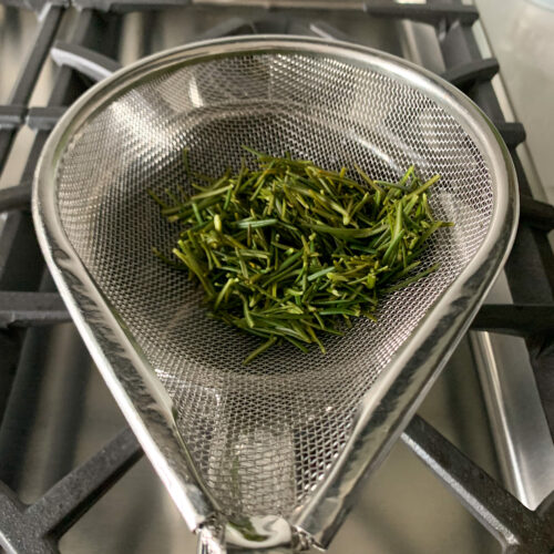 Image of Once fully boiling, drain the rosemary through a mesh strainer....