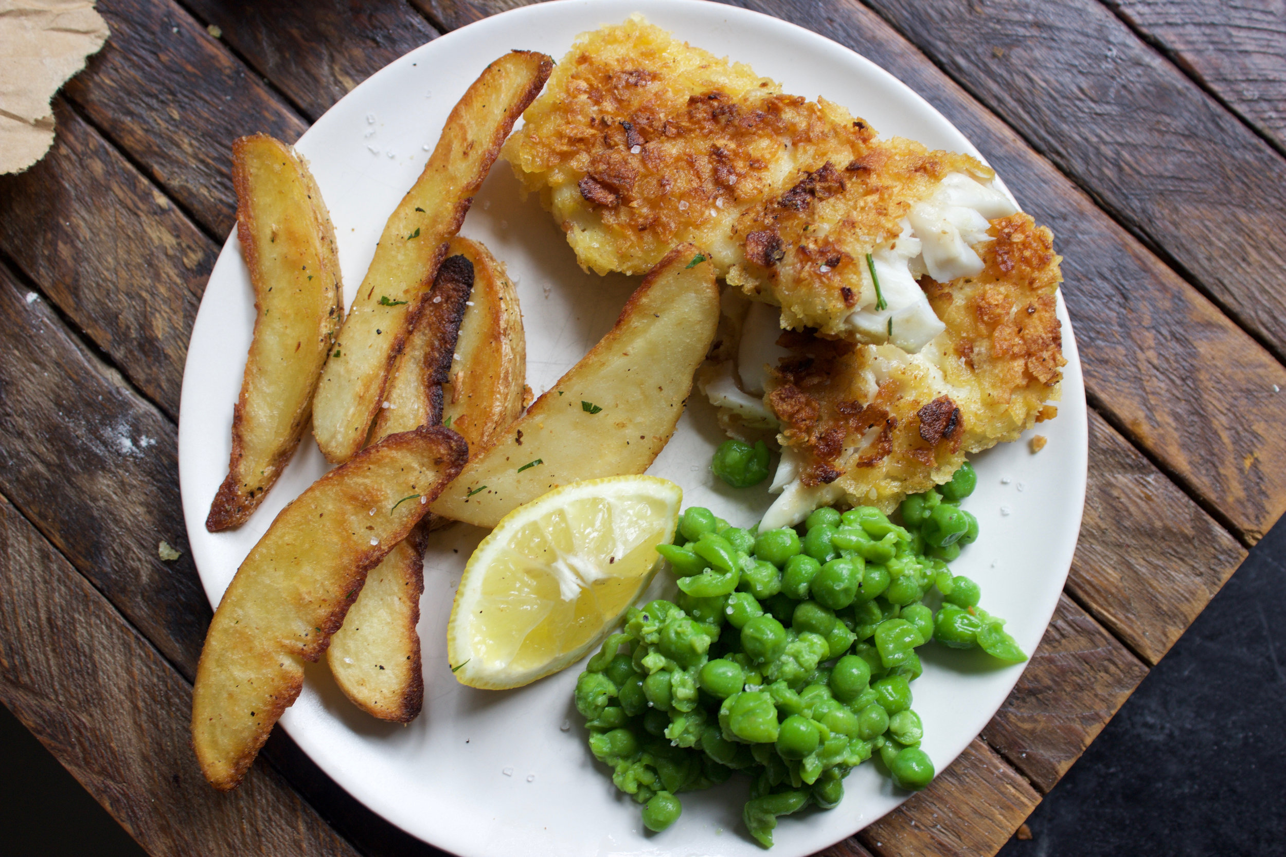 Image of Remove potatoes from the oven and take the fish off...