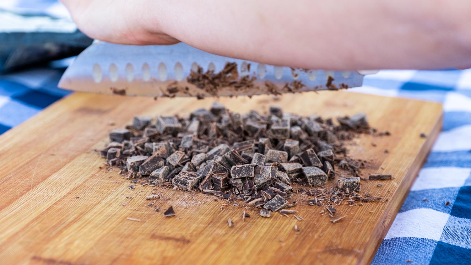 Image of Begin by chopping the pecans and chocolate chunks.