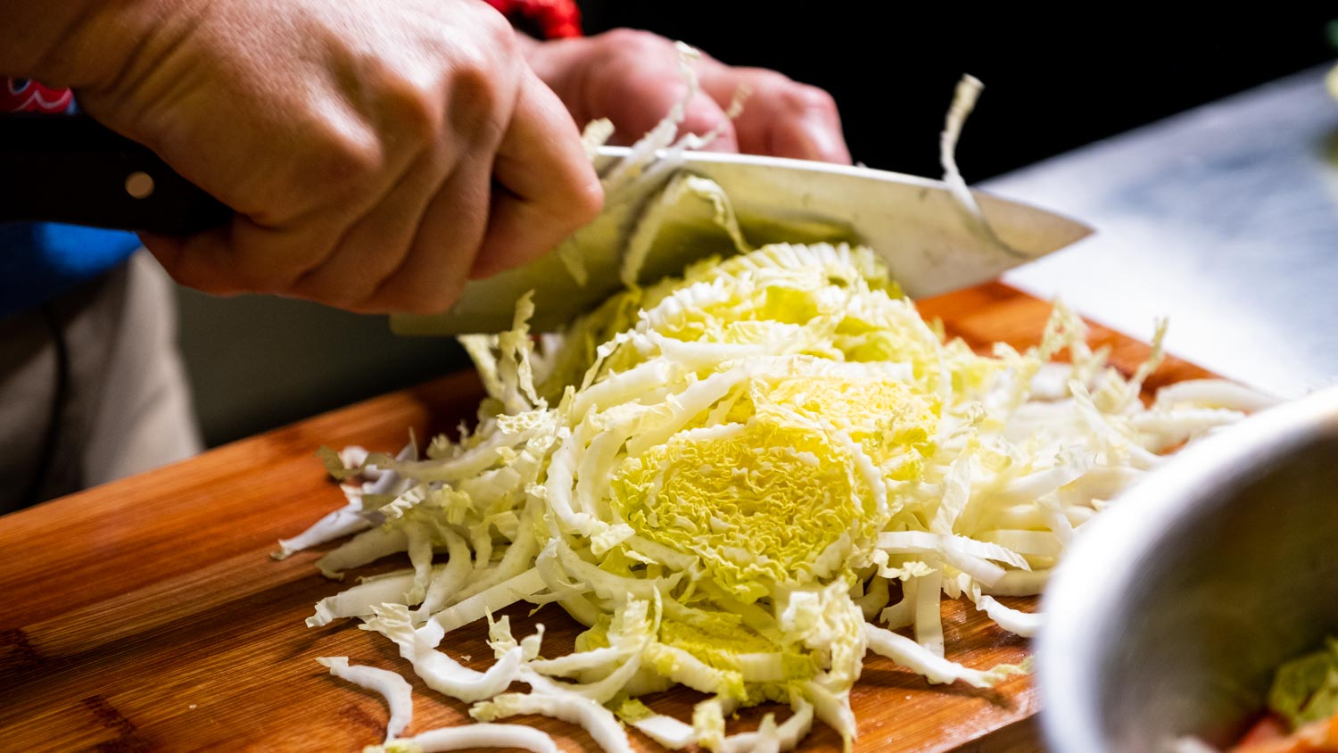 Image of Chop and add cabbage and carrots to a large bowl.