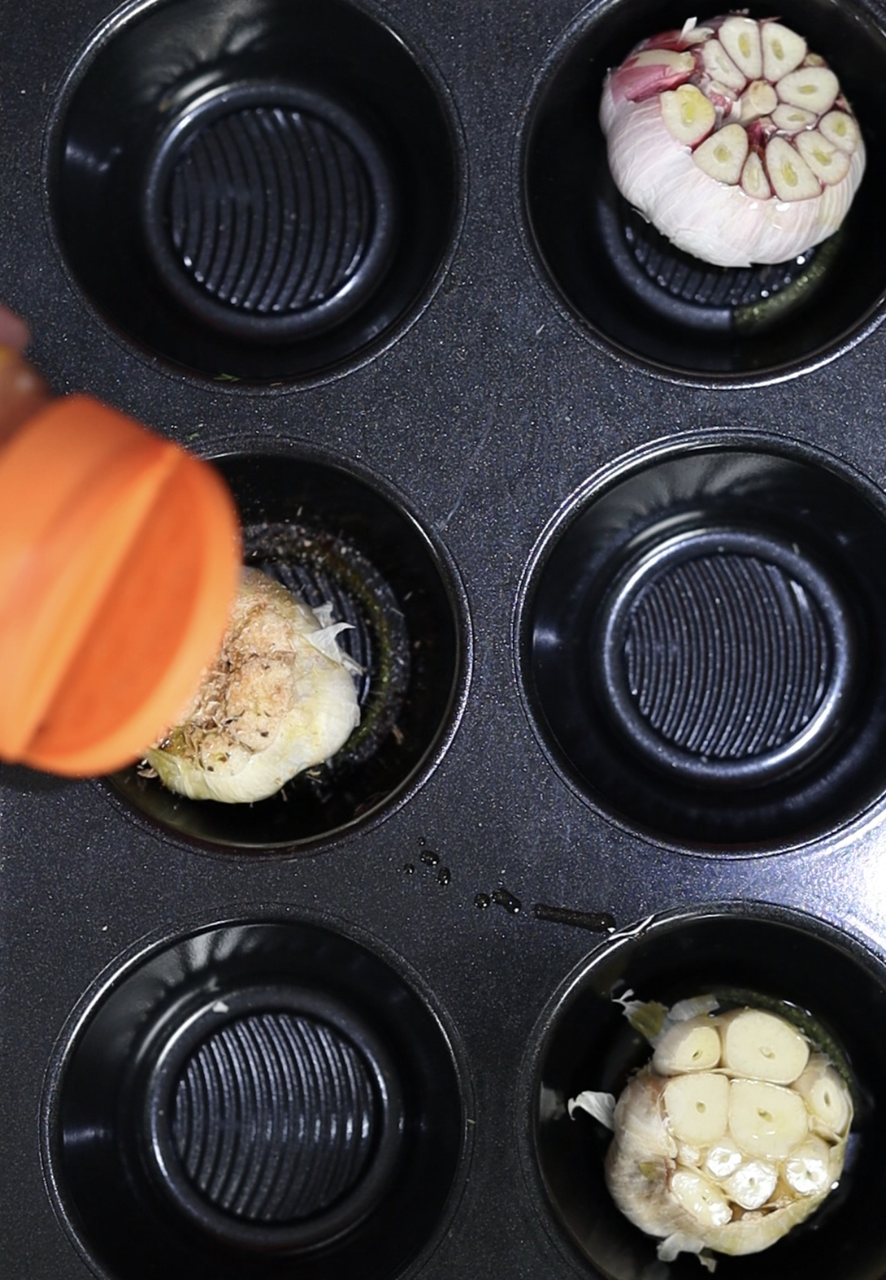 Image of Place the heads of garlic bread into your muffin tray....