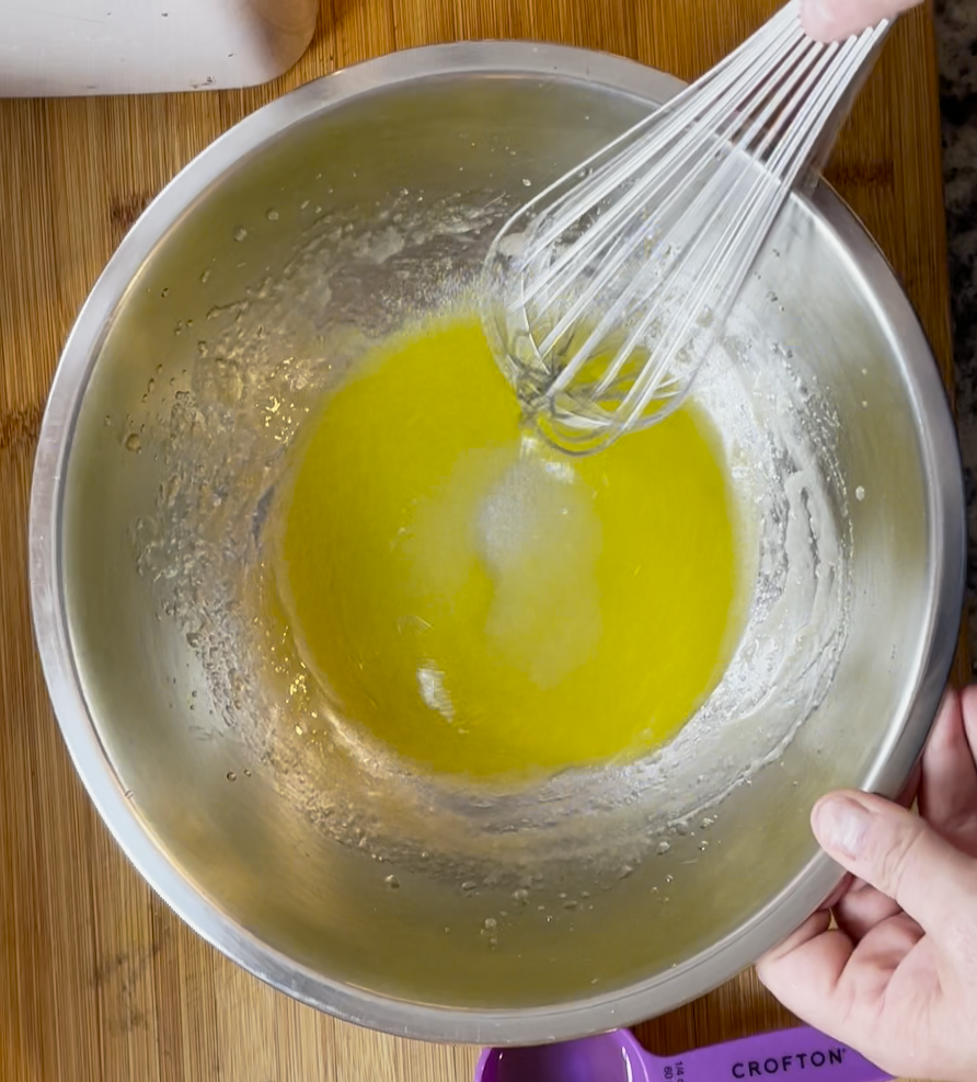 Image of Whisk olive oil and ice water together.