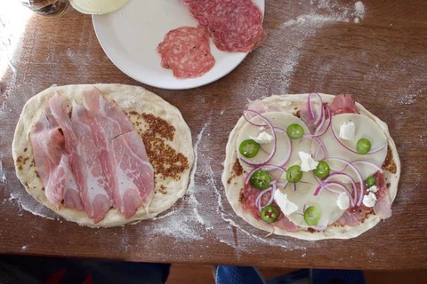 Image of Spread brown mustard all over the dough, leaving a ¼