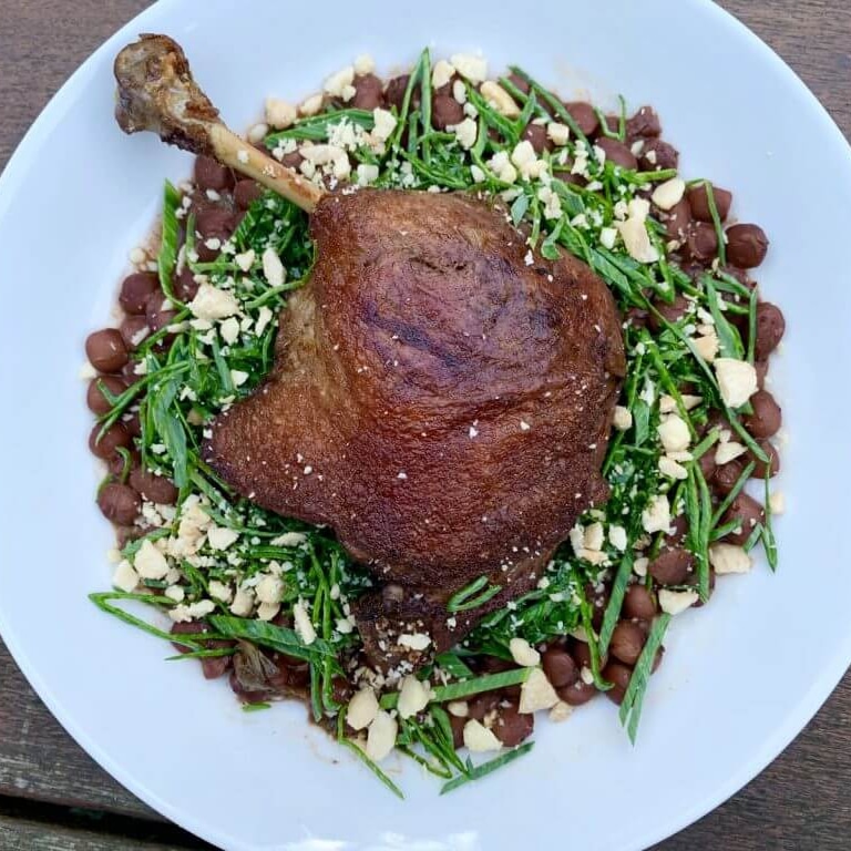Photo of Duck Confit over Beans with Spring Onion, Kale Salad
