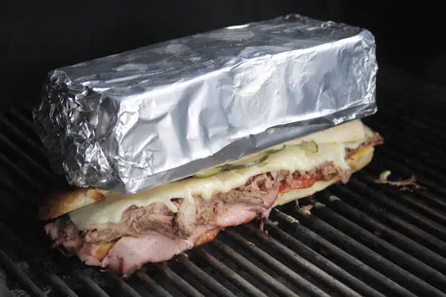 Image of Place the sandwich on the grill and weigh it down...
