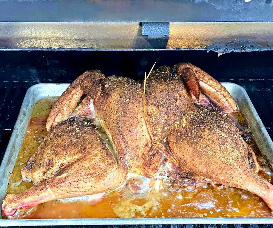 Image of Place the turkey on the smoker, skin-side up, and smoke...