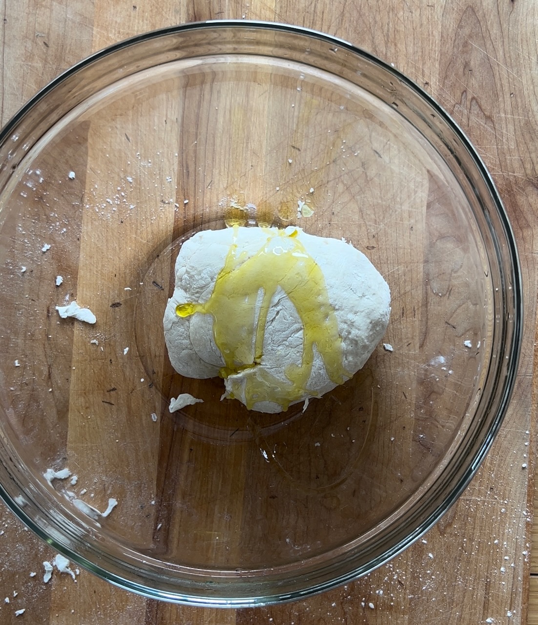 Image of Place dough back in bowl and drizzle olive oil on...