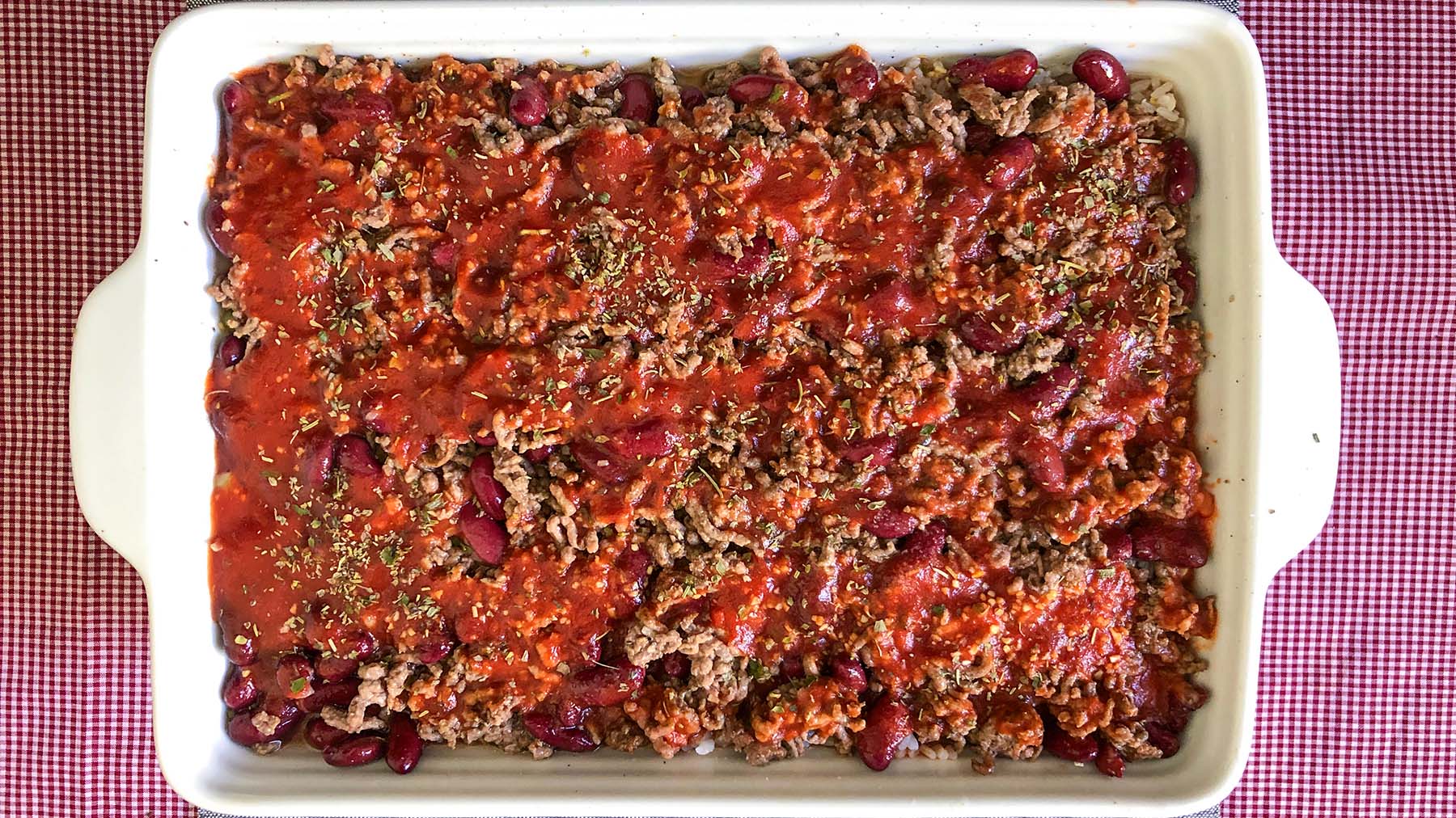 Image of Pour the beef and bean mixture over the rice and...