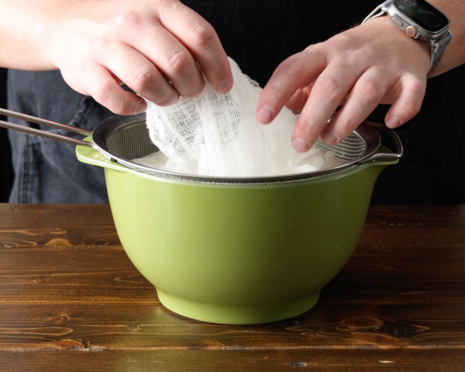 Image of Pour the yogurt mixture into the cheesecloth. Fold the cloth...