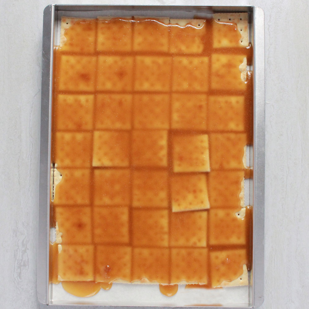 Image of Pour the boiling butter and sugar mixture evenly over the...