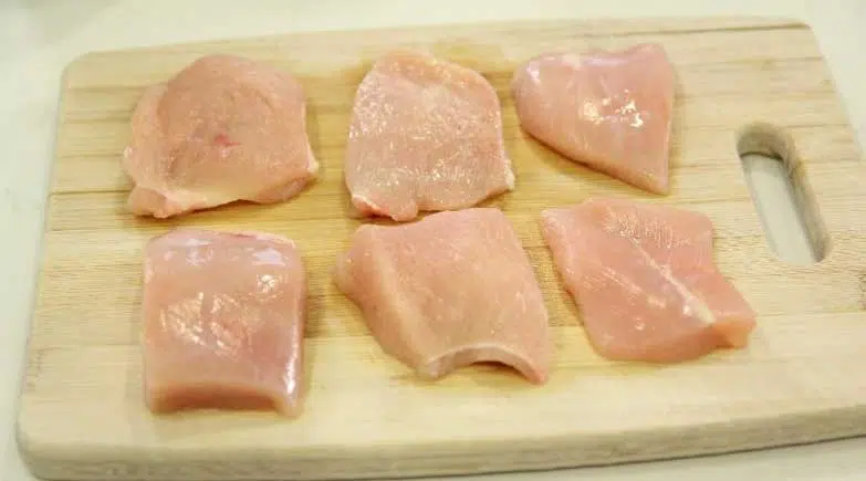 Image of Cut chicken breast horizontally and then in half vertically to...