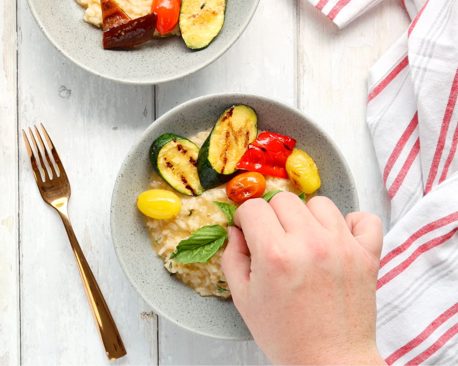 Image of Spoon risotto into a bowl, top with the grilled veggies...