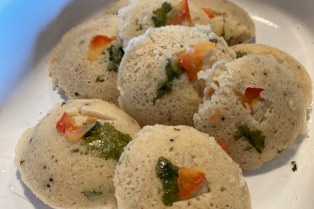 Image of Remove idlis from tray. I use a small rubber spatula...