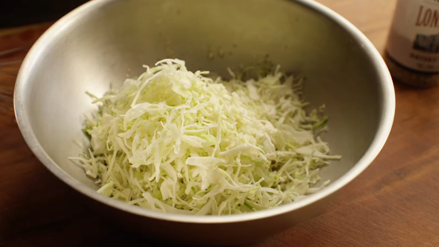 Image of To make the slaw, combine the Chile oil, vinegar and...