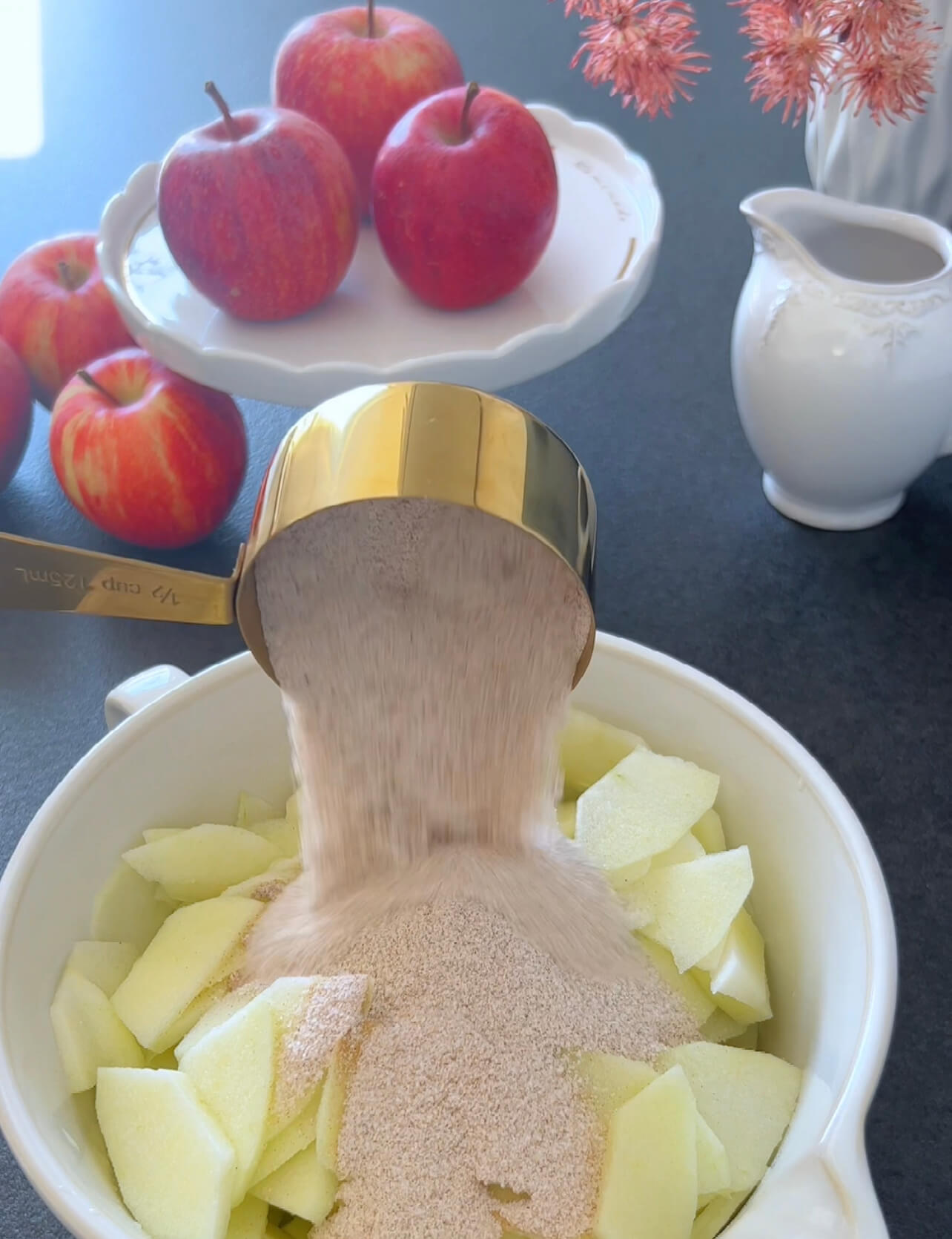 Image of In a bowl, combine the thin apple slices with sugar,...