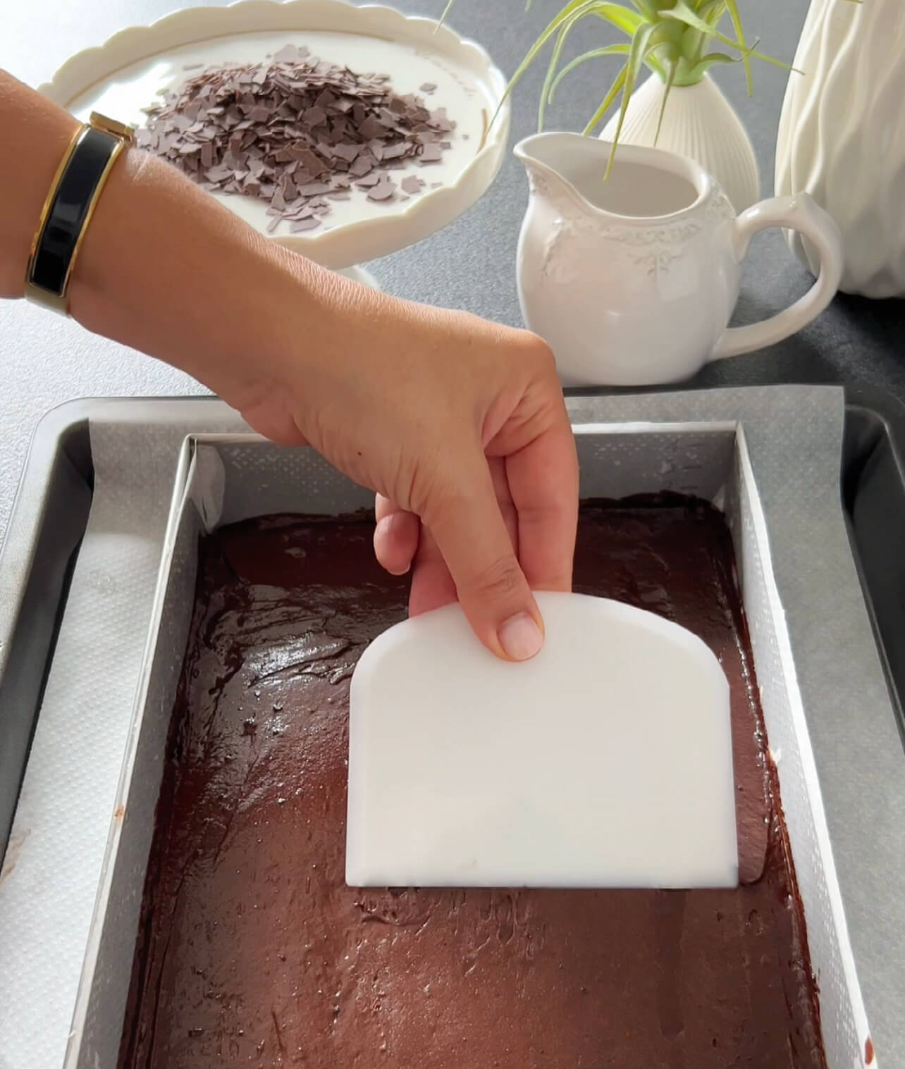 Image of Gently fold the melted chocolate-butter mixture into the batter until...