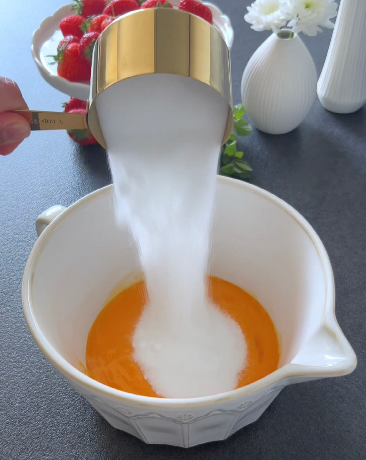 Image of In a bowl, beat the egg yolks with 150 grams...