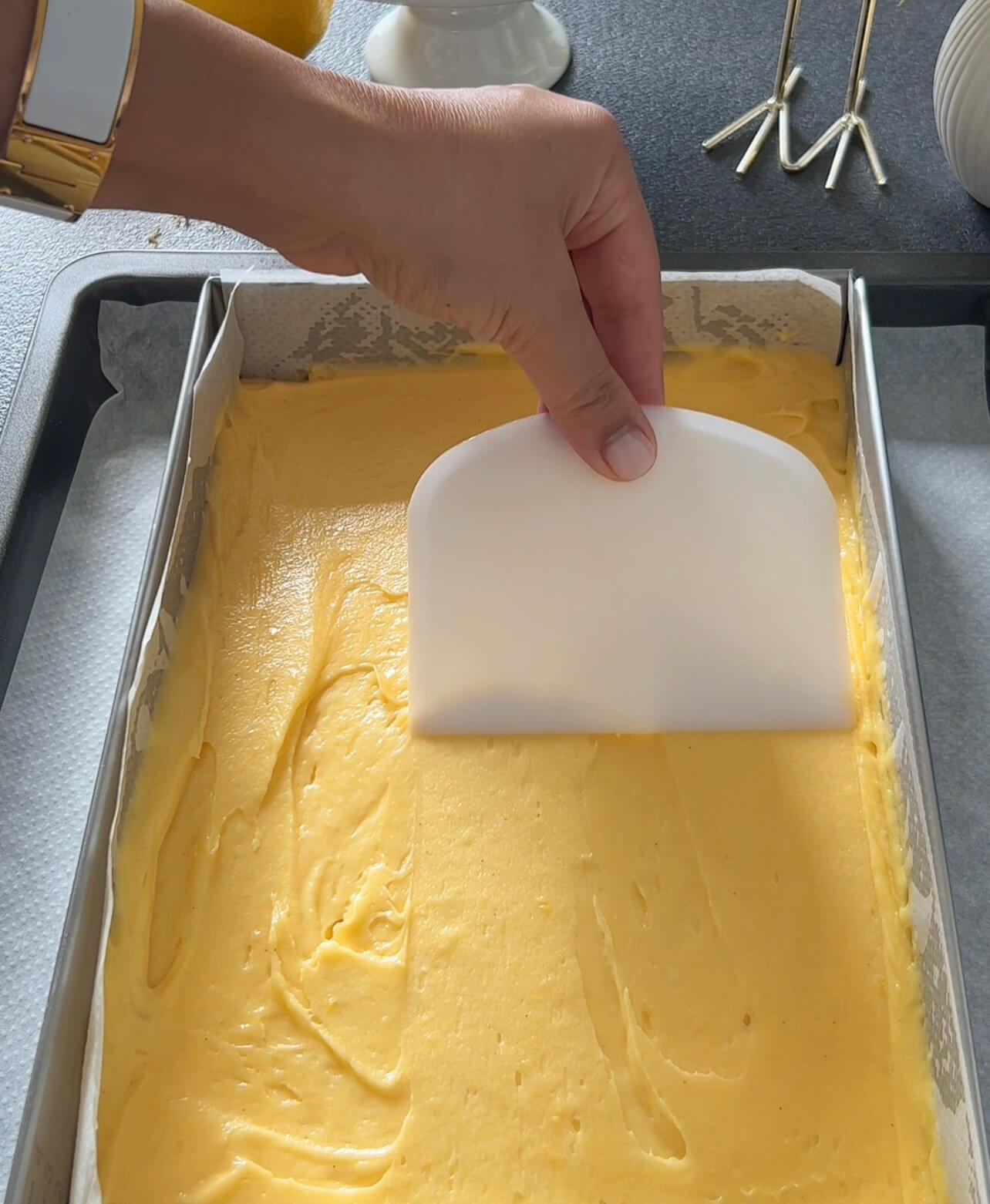 Image of Pour the batter into the prepared baking pan and spread...