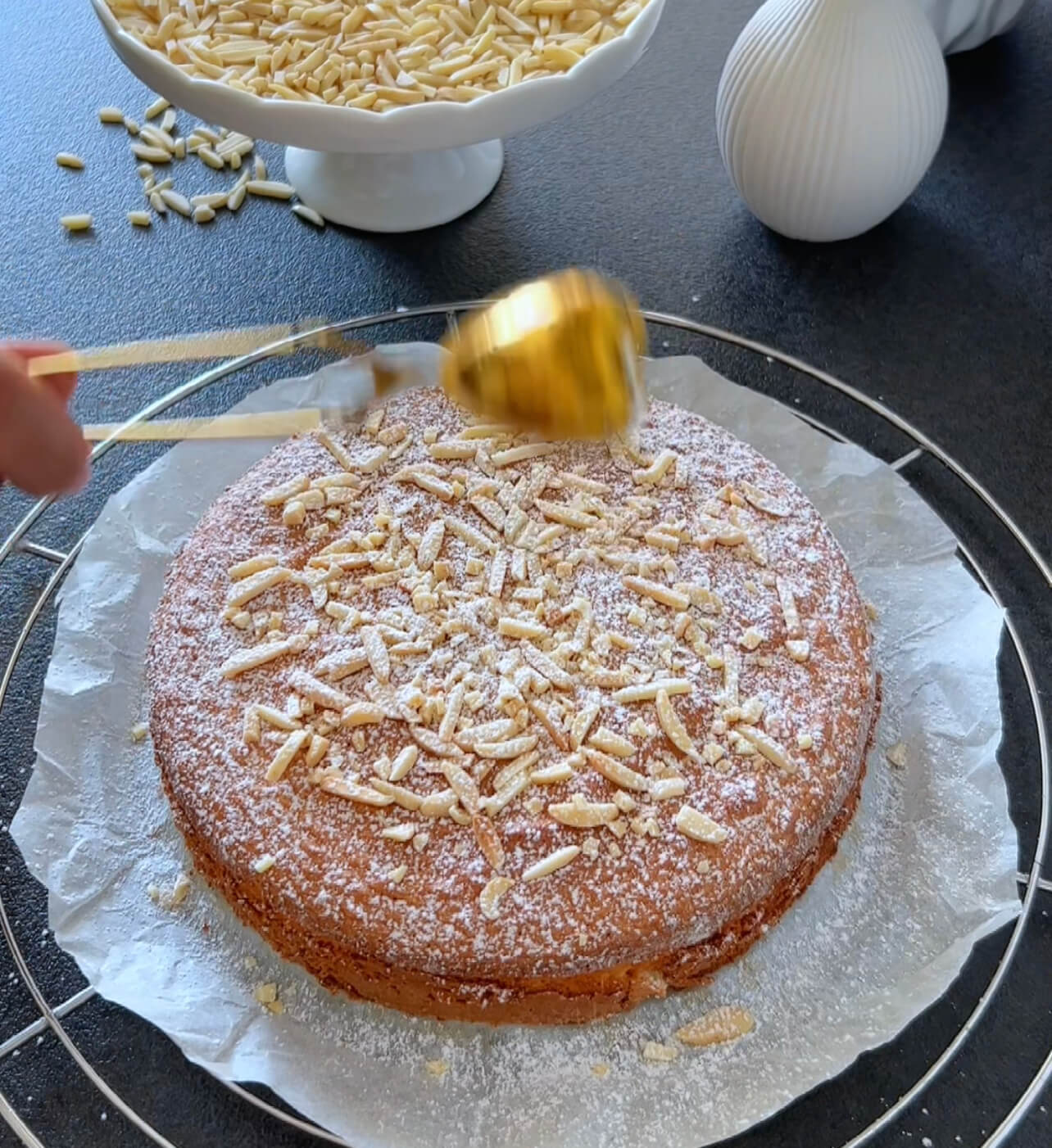 Image of Decorate the cooled cake with blanched almond slivers and dust...