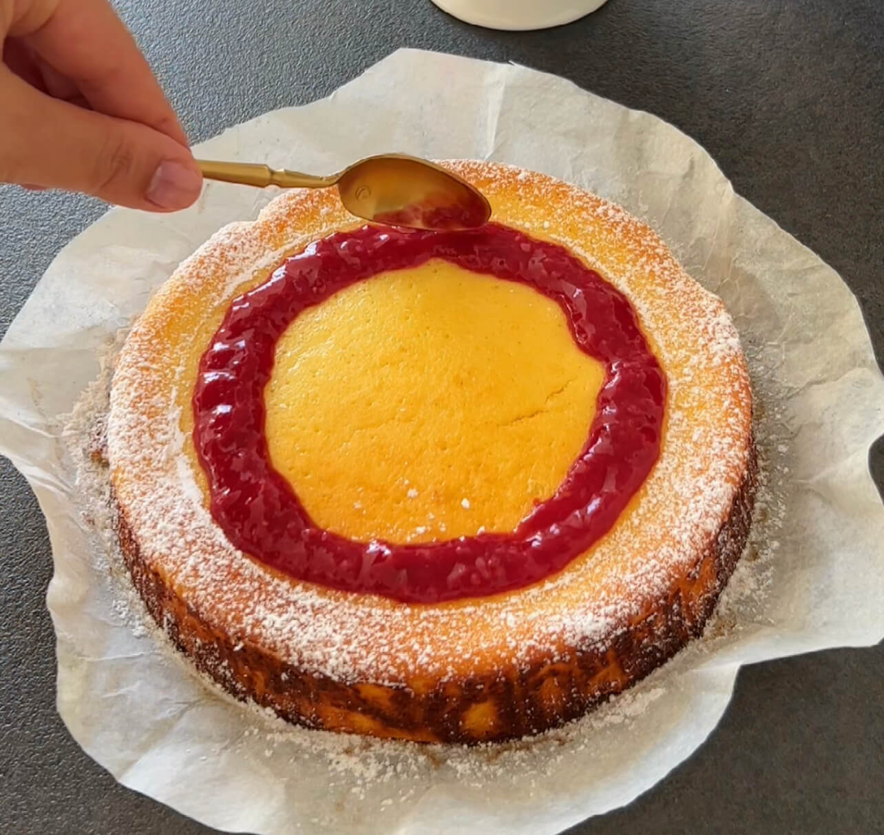 Image of Pour the raspberry sauce over your cooled cheesecake.