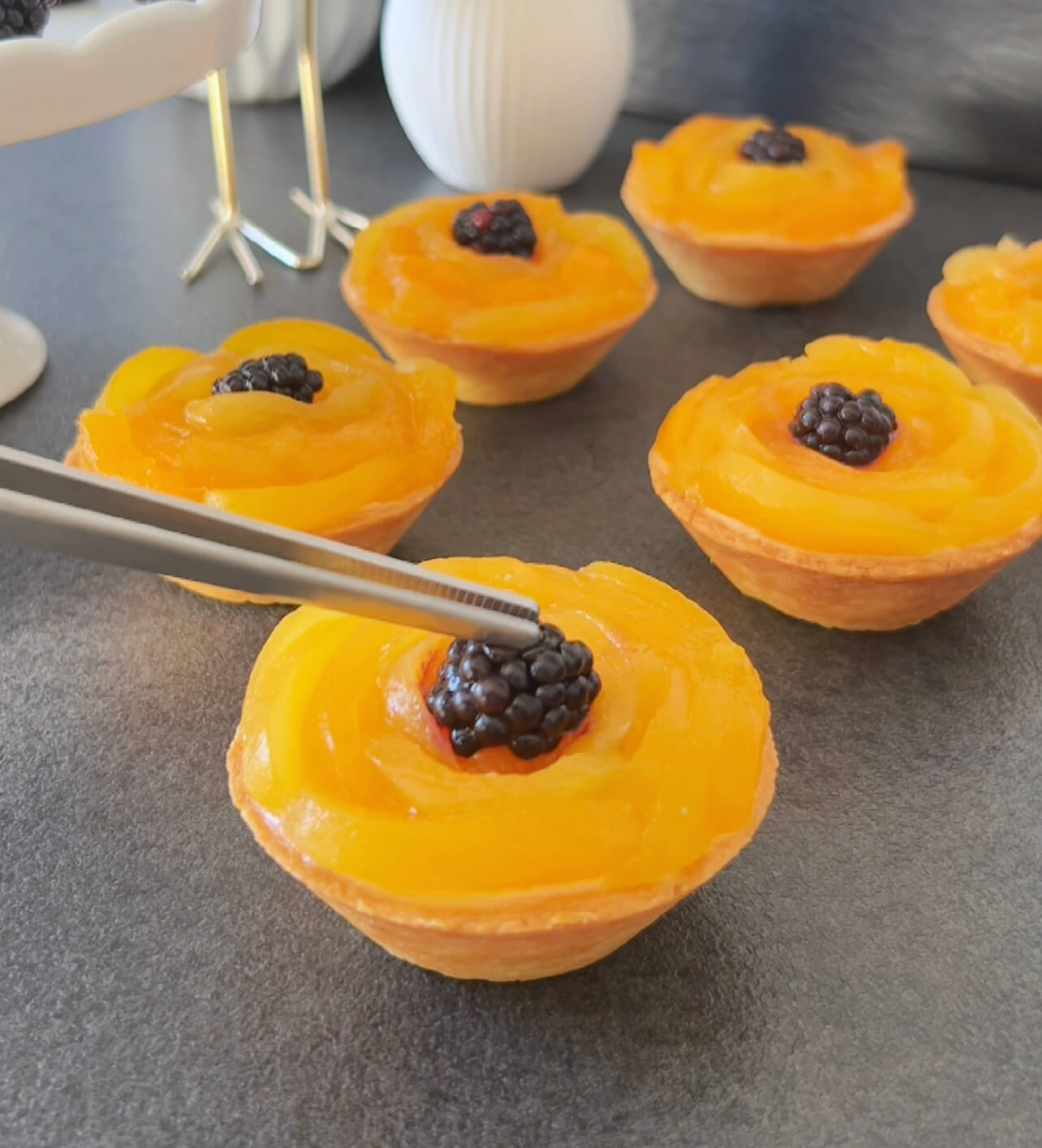 Image of Shape apricot strips into roses, adding a berry in the...