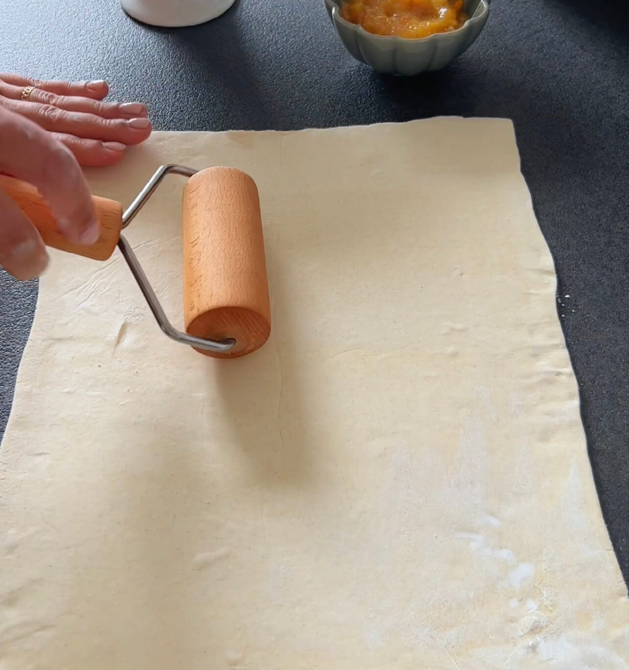 Image of Cut the rolled-out puff pastry into 12 even strips, each...