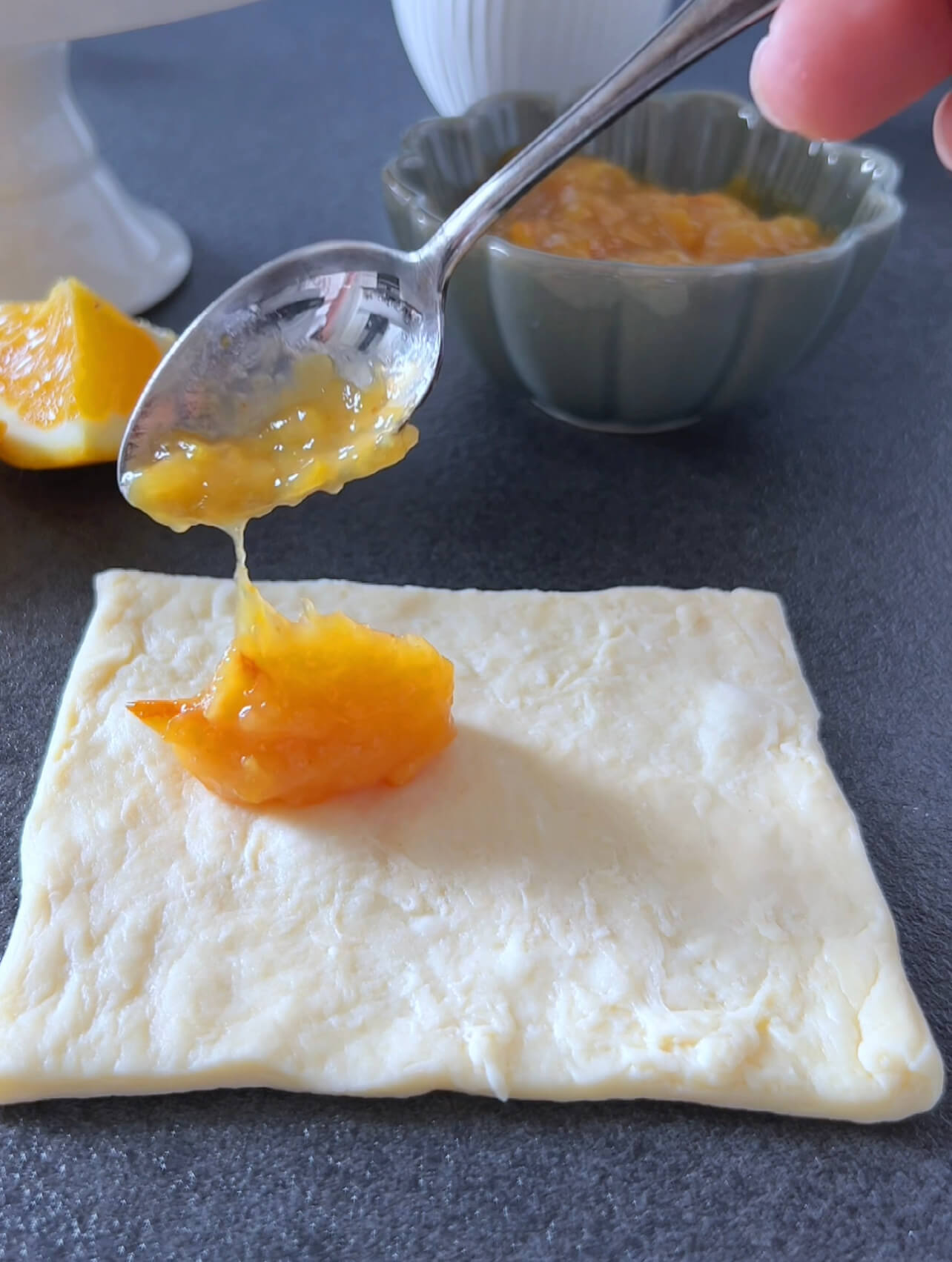 Image of Spread orange marmalade on one square. Fold the corners of...