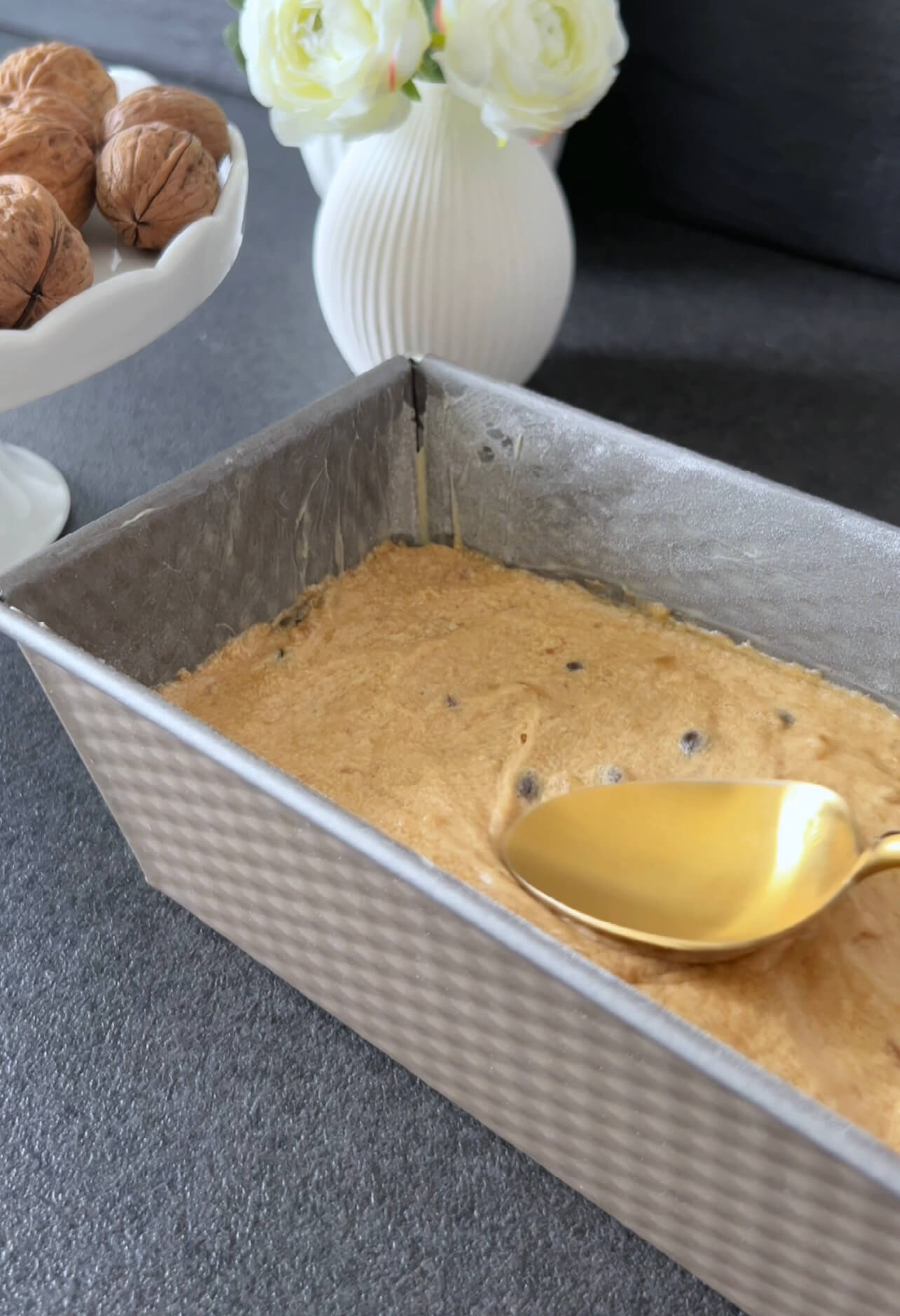 Image of Pour the batter into the prepared loaf pan and smooth...