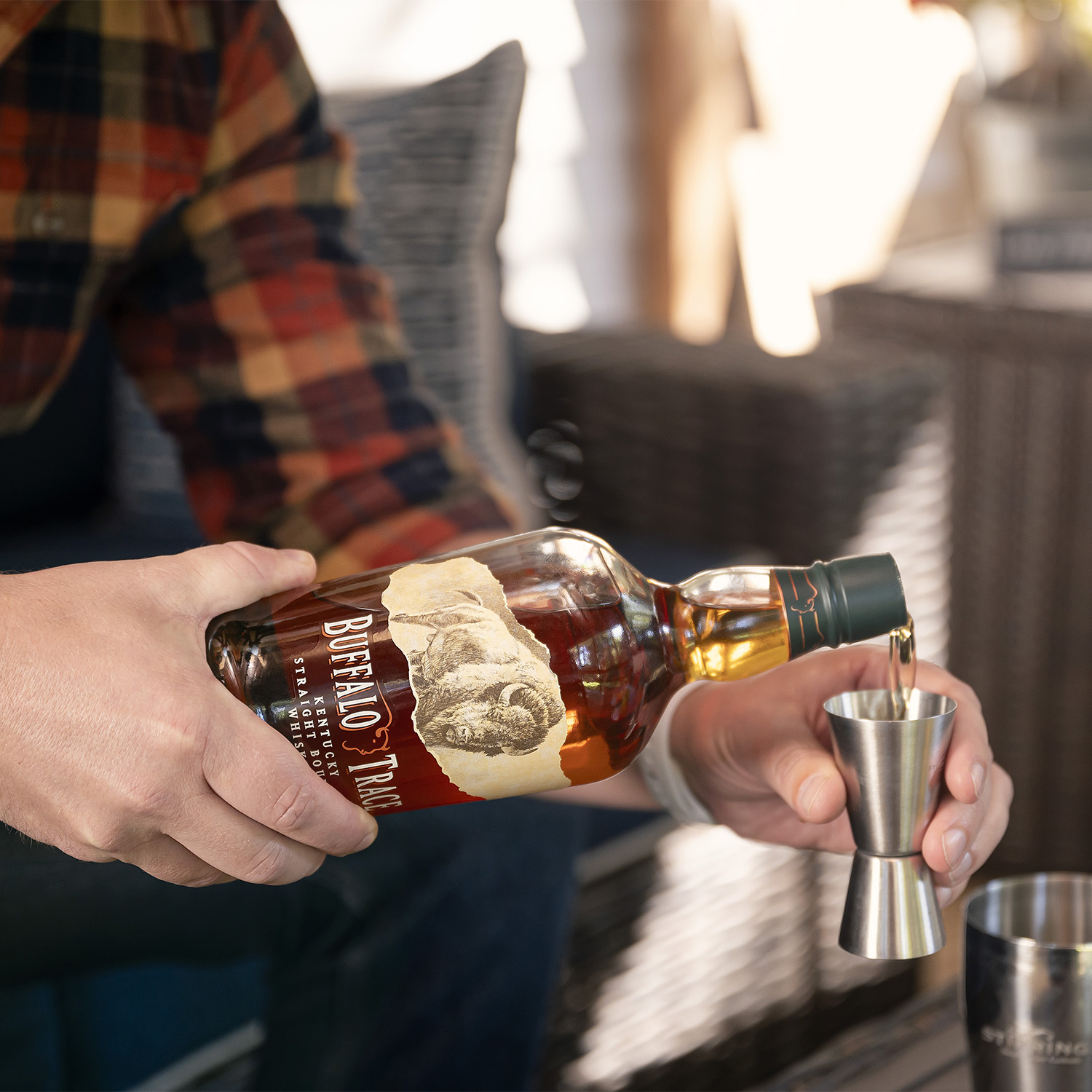 Image of Add 4 ounces of Buffalo Trace Bourbon to the shaker.