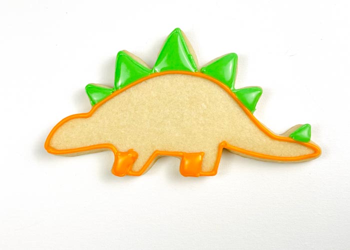 Image of Once the orange outline is relatively dry, use green piping...