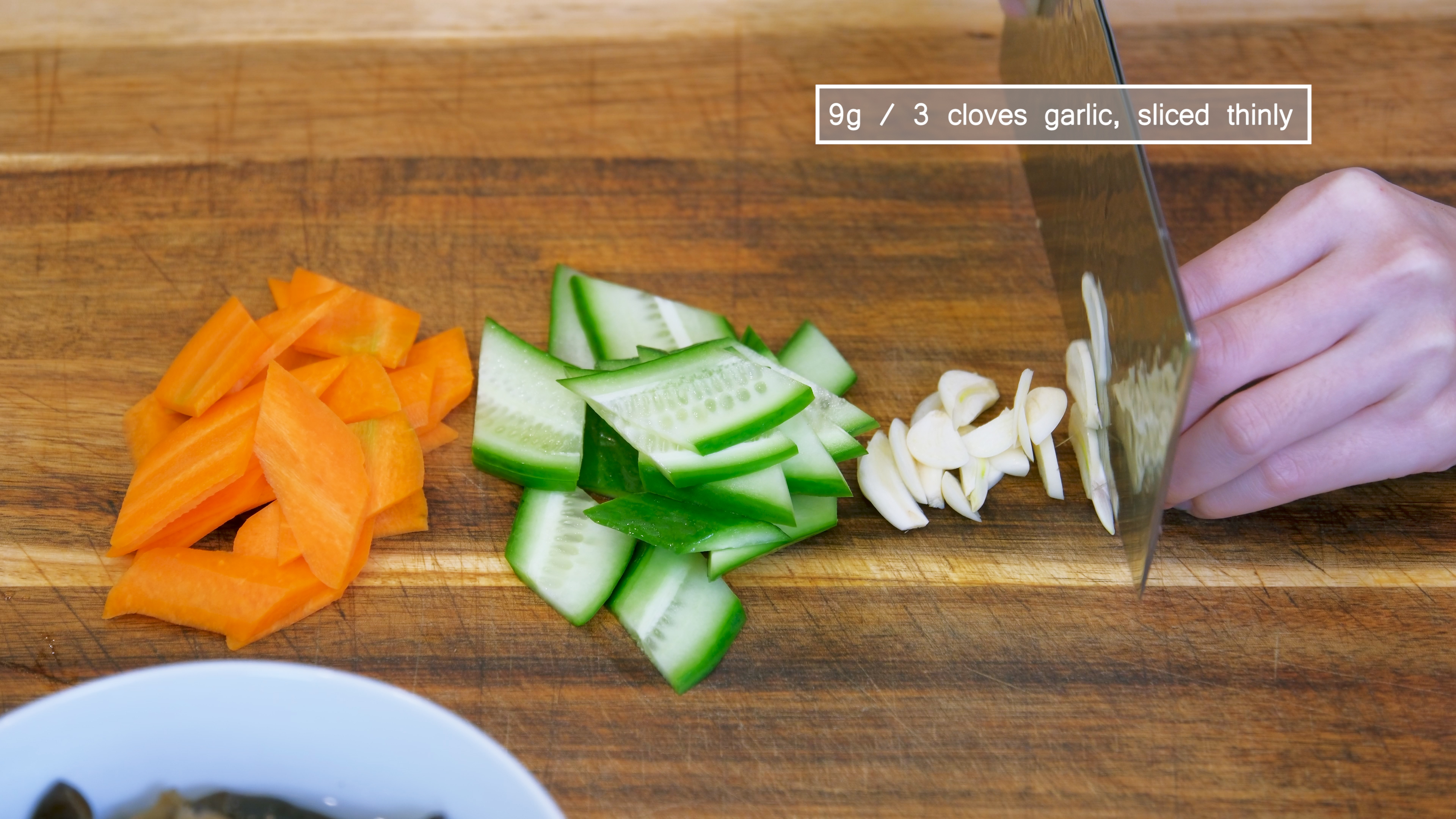Image of Cut the carrot, cucumber, and garlic into thin slices. I...