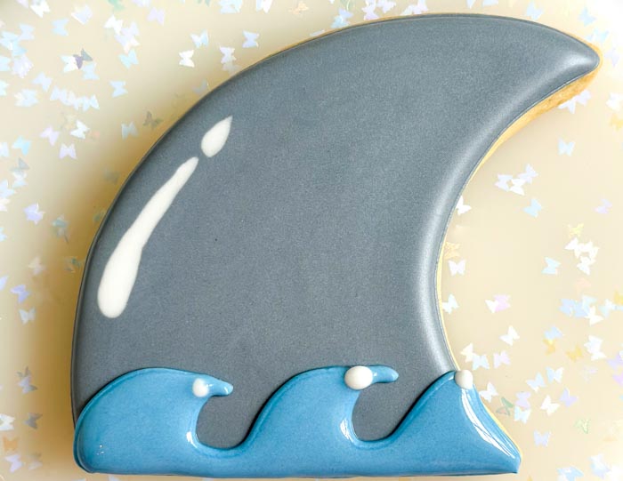 Image of Moving quickly while the blue icing is still wet, pipe...