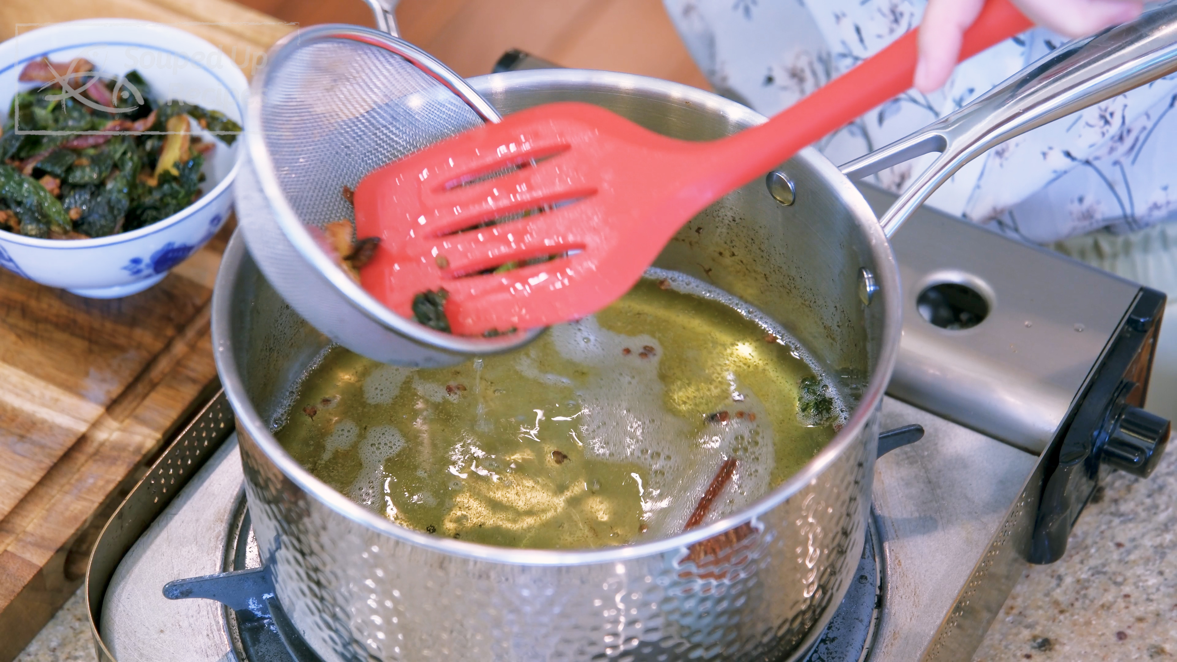 Image of Use a strainer to sieve out all the aromatics and...