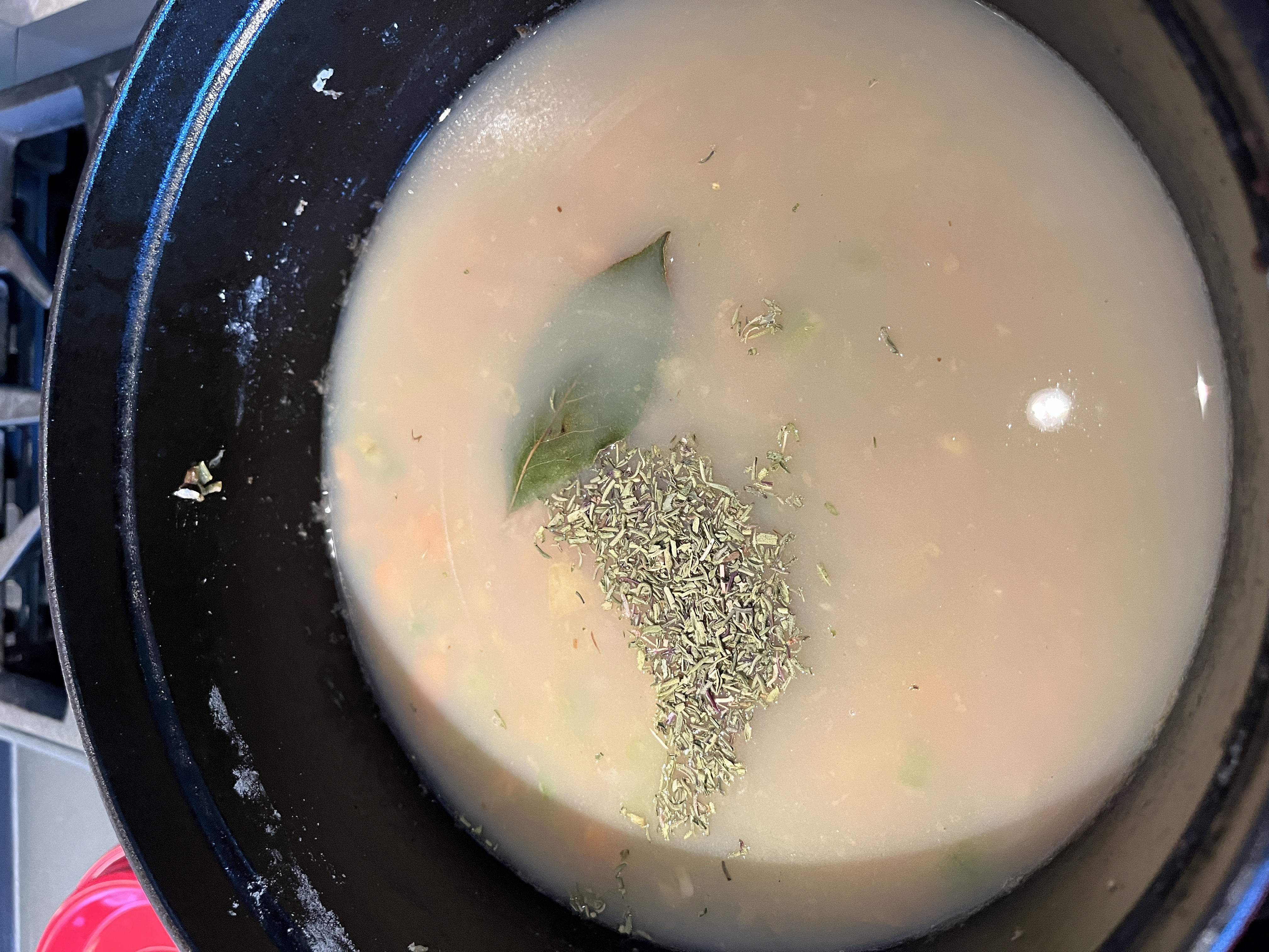 Image of Add 2 cups chicken broth, reserved clam juice, bay leaf,...