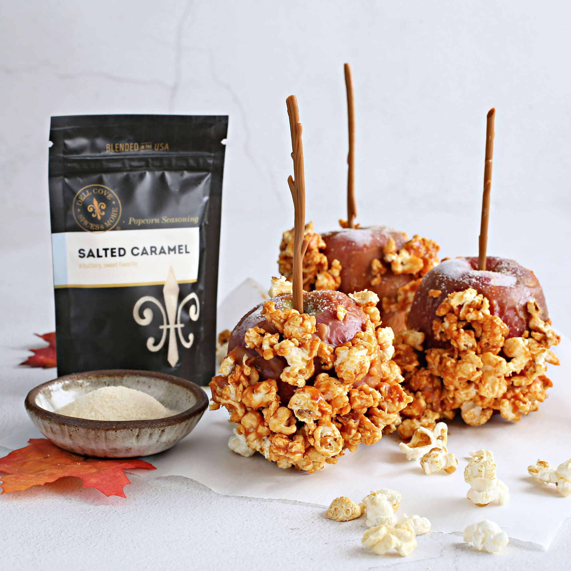 Image of Fill a bowl with popcorn. Dip each apple thoroughly into...