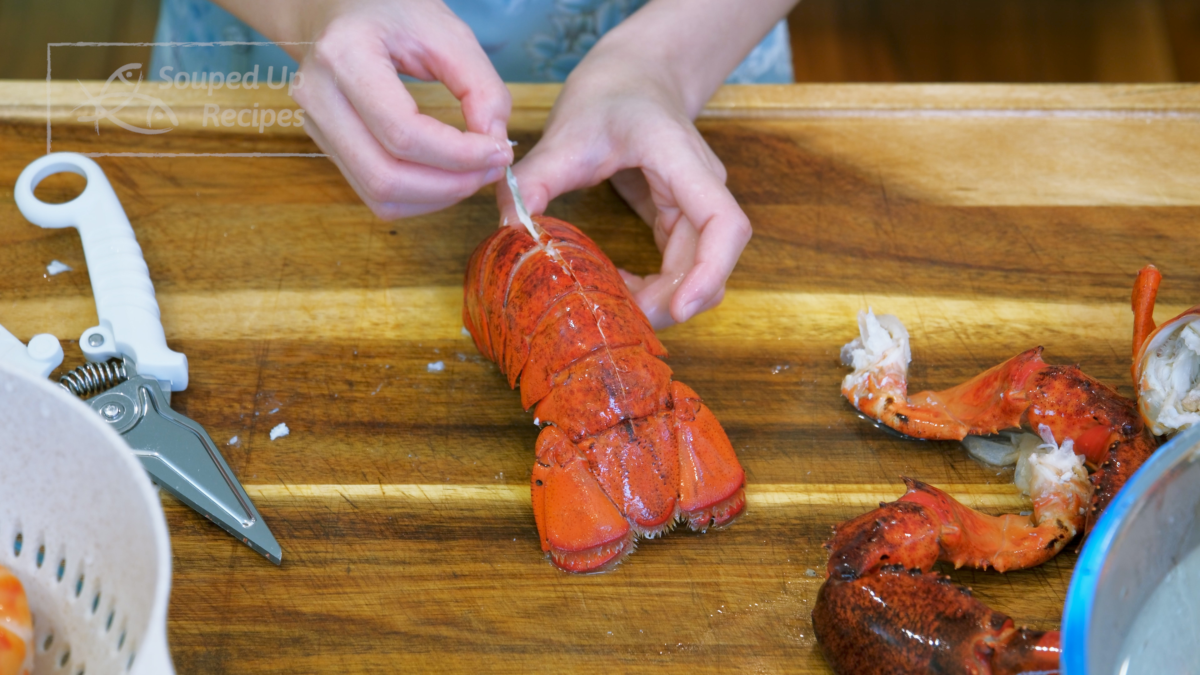 Image of Detach the the lobster tail from the head by twisting...