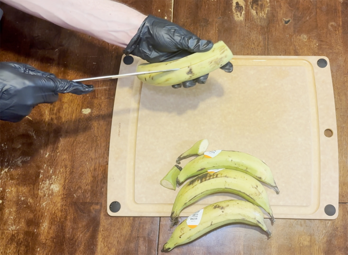 Image of Cut the ends off of the plantains. Take a knife...