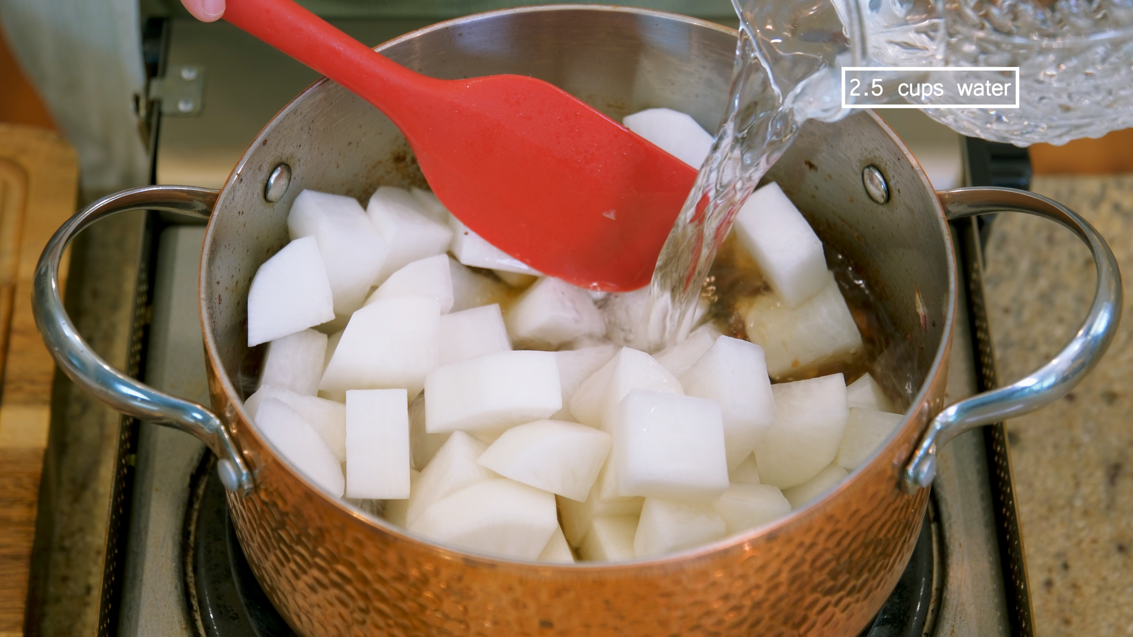 Image of Add the daikon radish and pour in 2.5 cups of...