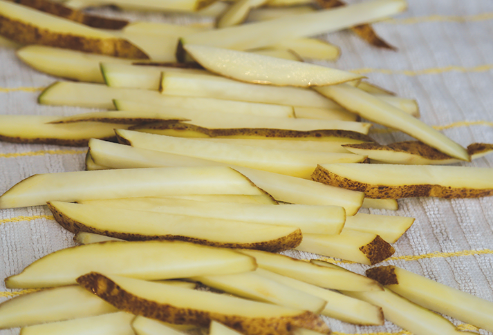 Image of Cut the potatoes into nice thin fries and place in...