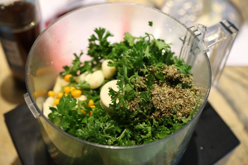 Image of Place the parsley, garlic, peppers, salt, and pepper in a...